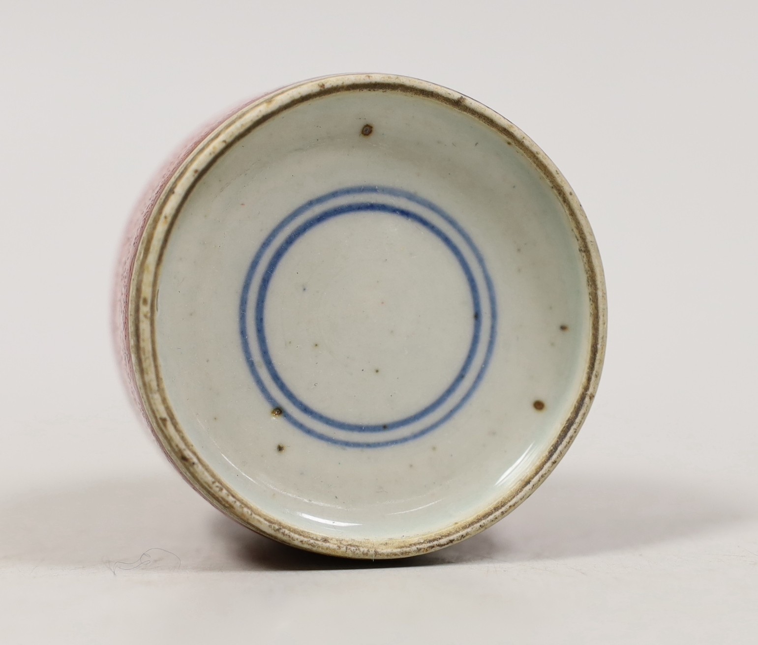 A Chinese red glazed brushwasher. 6cm tall
